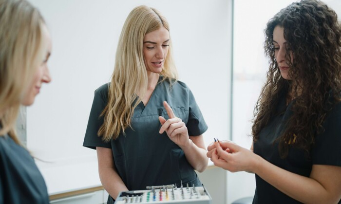 Drei Assistentinnen der Praxis bei der Vorbereitung einer Behandlung