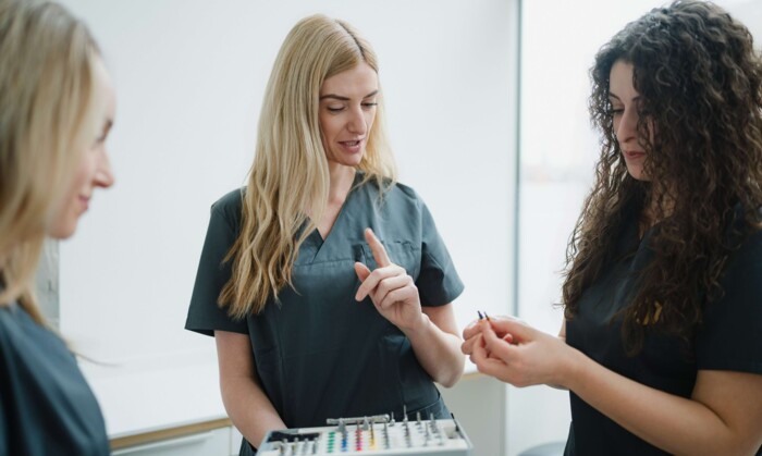 Drei Assistentinnen der Praxisklinik w&auml;hrend der Vorbereitungen f&uuml;r einen Eingriff im Behandlungszimmer
